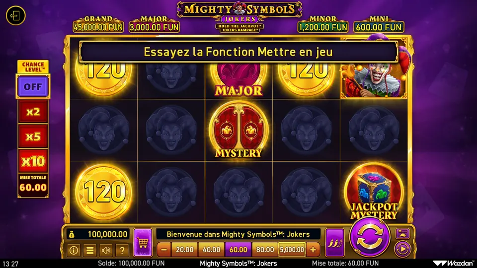 Grille de Mighty Symbols: Jokers, 3 rangées de 5 cases, en partie couverte en haut par le bandeau « Essayez la Fonction Mettre en jeu » : trois pièces dorées 120, une pièce rose MAJOR, un bouffon au chapeau à grelots en haut à droite, un symbole rouge MYSTERY au centre, un symbole JACKPOT MYSTERY en bas à droite et des cases vides marquées d’un visage sombre ; en haut les jackpots GRAND 45,000.00 FUN, MAJOR 3,000.00 FUN, MINOR 1,200.00 FUN et MINI 600.00 FUN, à gauche le Chance Level™ sur OFF et une mise totale de 60.00